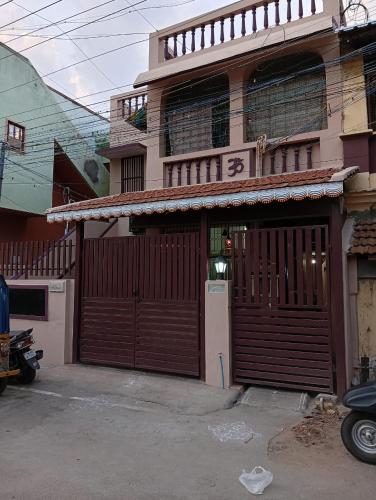 a building with two garage doors in front of it at Kallidai Home Stay Kumbakonam in Kumbakonam