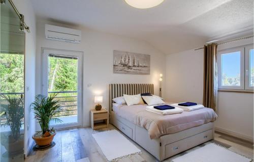 a bedroom with a bed and a large window at Villa Punte Bianche in Zadar