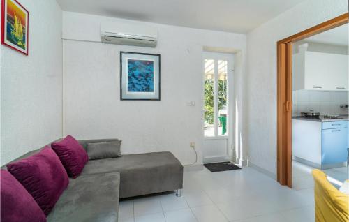 a living room with a couch and a kitchen at 2 Bedroom Cozy Apartment In Jadranovo in Jadranovo