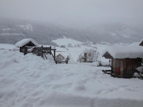 a pile of snow in front of a house at Hansalagut in Mauterndorf