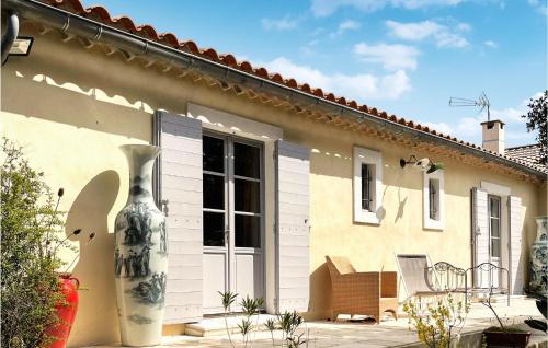 a large vase sitting outside of a house at Nice Home In Venasque With Kitchen in Venasque