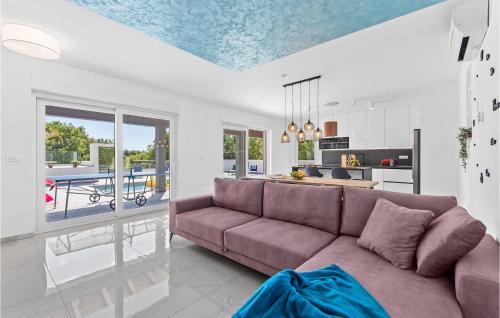 a living room with a couch and a kitchen at Villa Casa Mara in Pula