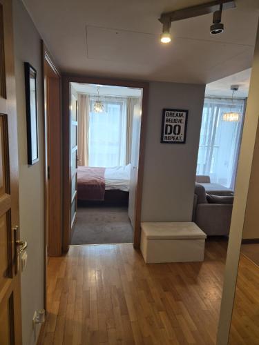 a hallway with a room with a bed and a sign at Sea Towers Gdynia in Gdynia