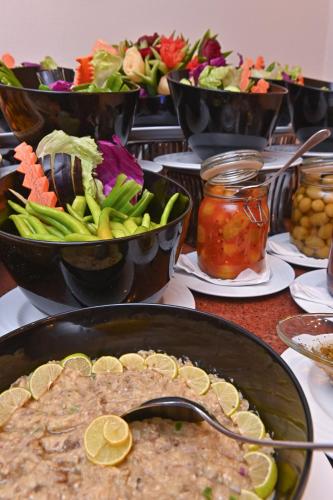 a table topped with bowls of food and salads at Swiss Inn Nile Hotel in Cairo