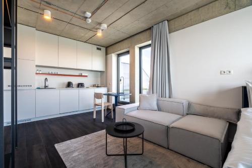 a living room with a couch and a table at HONEST Ricany in Ricany