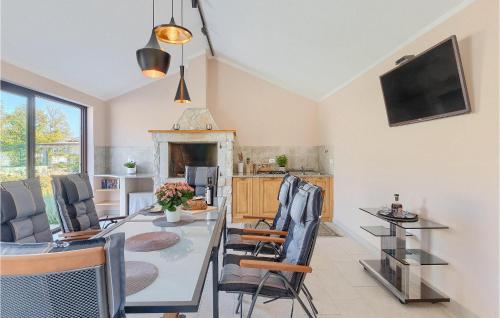 a kitchen and dining room with a table and chairs at Villa Mendula in Potpićan
