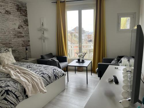 a bedroom with a bed and a living room at NOUVEAU AU COEUR DES CORDIERS ! QUARTIER HISTORIQUE in Le Tréport