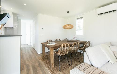 a kitchen and dining room with a wooden table and chairs at Nice Home In Voorthuizen With Wifi in Voorthuizen