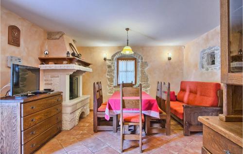 a dining room with a table and a fireplace at Villa Stancija Bursic in Pula