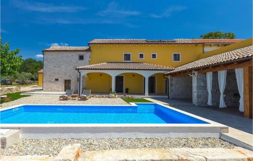 a villa with a swimming pool in front of a house at Villa Lanca in Poreč