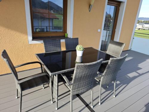a table and chairs on a porch with a table and chairs at Ferienwohnung Wallner in Hof bei Salzburg