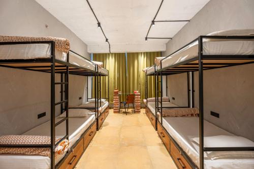 a room with four bunk beds in a dorm at Local Lok in Varanasi