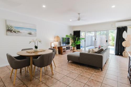 a living room with a couch and a table at Tropical 2 BR, 2 Bath Villa with private pool in Palm Cove