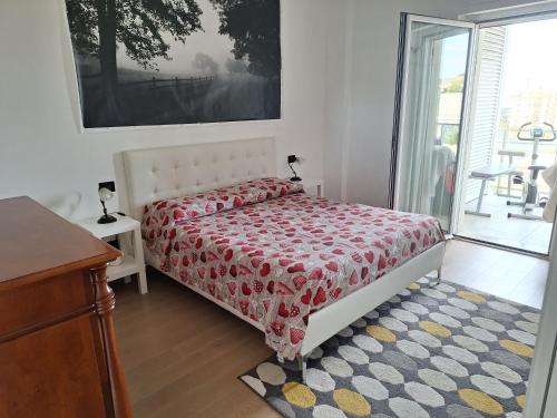 a bedroom with a bed with a red comforter at Boulevard Suite in Bari