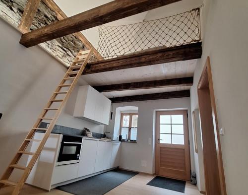a kitchen with a ladder in a room at Apartment Stadtmauerloft Gmünd in Gmünd in Kärnten