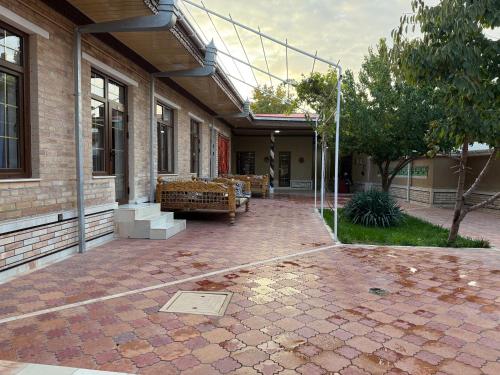 a courtyard of a building with benches on it at Salomat guest house in Samarkand