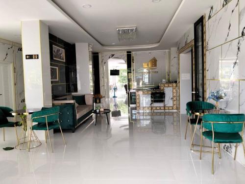a lobby with green chairs and a living room at Kiree River Hotel โรงแรมคิรีริเวอร์ in Ban Thong Pha Phum