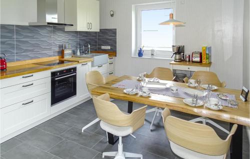 a kitchen with a wooden table and chairs at Beautiful Home In Groß Schwansee in Groß Schwansee