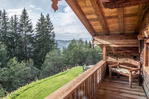 a log cabin balcony with a view of the mountains at Buccara Zwischenbachalm in Westendorf