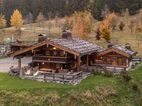 a large wooden house with a roof at Buccara Zwischenbachalm in Westendorf