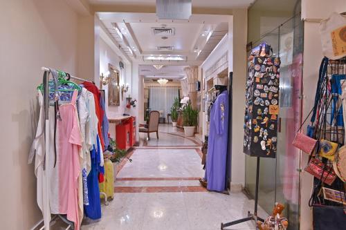 a store hallway with clothes on racks in a room at Swiss Inn Nile Hotel in Cairo