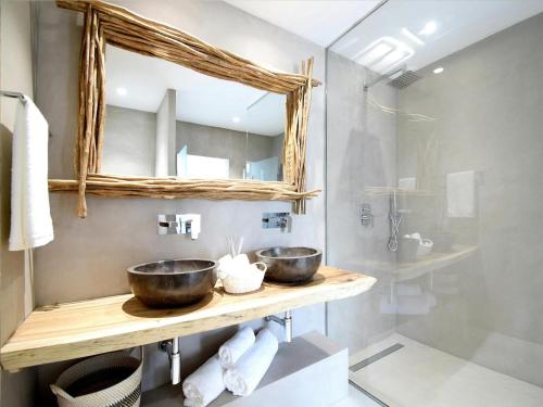 a bathroom with two bowls on a wooden counter at Villa in Ibiza with Sea Views and Jacuzzi in Es Cubells