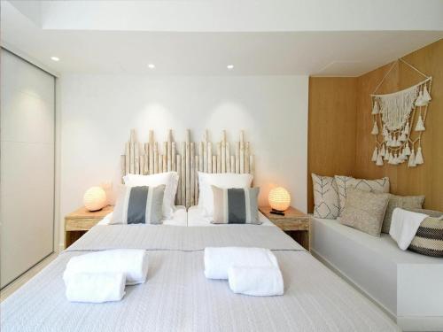 a bedroom with a large bed with two pillows at Villa in Ibiza with Sea Views and Jacuzzi in Es Cubells
