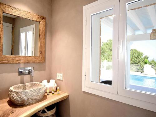 a bathroom with a sink and a window at Villa in Ibiza with Sea Views and Jacuzzi in Es Cubells