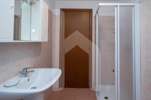 a bathroom with a sink and a shower at Homiday - Villa Mila in Pineto