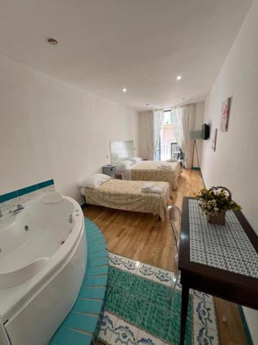 a bathroom with a bath tub and a living room at SALERNO COSTA D'AMALFI SUITE in Salerno