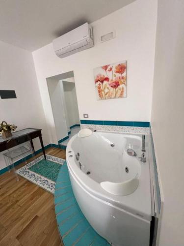 a bathroom with a large white tub in a room at SALERNO COSTA D'AMALFI SUITE in Salerno
