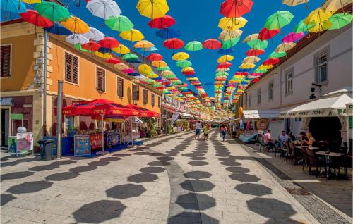 a street with umbrellas hanging from the ceiling at Awesome Home In Zasadbreg in Zasadbreg