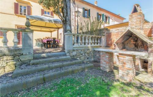 a house with a stone staircase leading to a patio at Villa Pieve, Lucignano in Lucignano