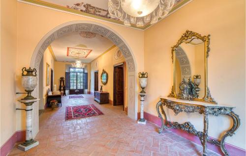 an ornate hallway with a mirror on the wall at Villa Pieve, Lucignano in Lucignano
