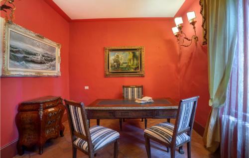 a dining room with a table and two chairs at Villa Pieve, Lucignano in Lucignano