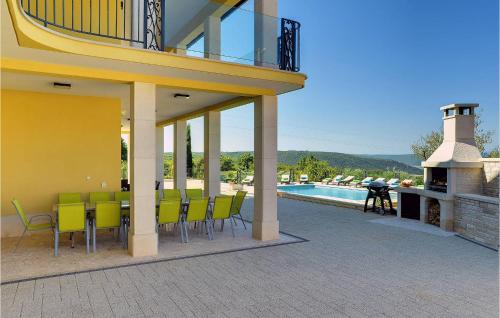 a patio with green chairs and a swimming pool at Villa Rachele in Pula