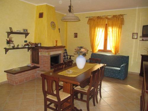 a living room with a table and a fireplace at B&B Sole del Pollino in Rotonda