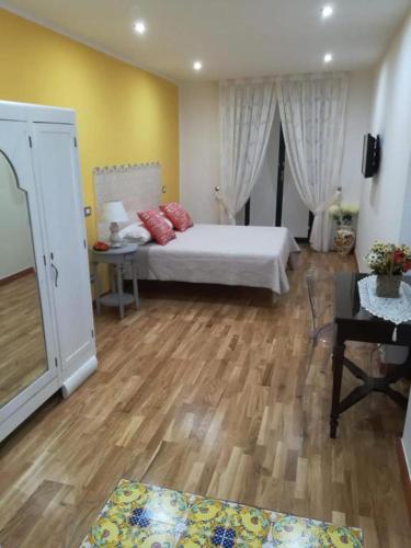a bedroom with a bed and a wooden floor at SALERNO COSTA D'AMALFI SUITE in Salerno