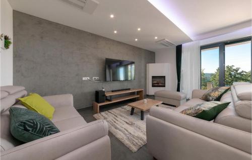 a living room with two couches and a tv at Villa Althea in Ružići