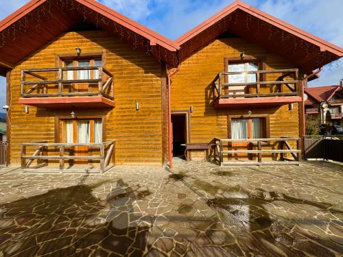 a house with two balconies on the side of it at Опришок in Palyanytsya