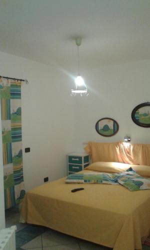 a bedroom with a bed with a light above it at casa di campagna dal pozzo in Sorso