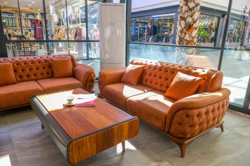 two leather couches and a coffee table in a store at Days Inn by Wyndham Alanya in Alanya