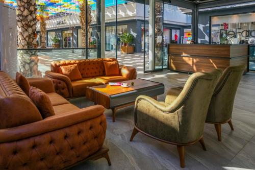 a lobby with couches and chairs in a store at Days Inn by Wyndham Alanya in Alanya