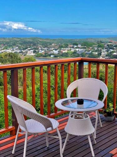 a patio with two chairs and a table on a deck at Seaside Retreat in Kenton-on-Sea in Kenton on Sea