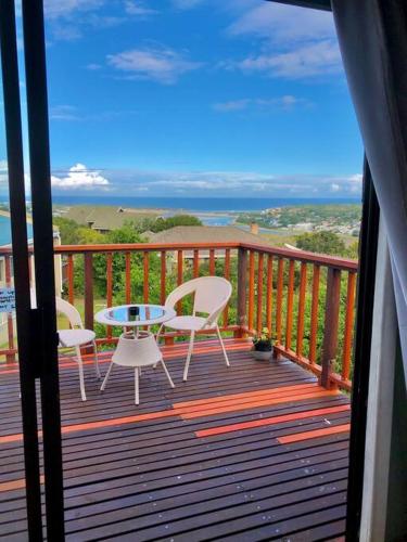 a balcony with a table and chairs on a deck at Seaside Retreat in Kenton-on-Sea in Kenton on Sea