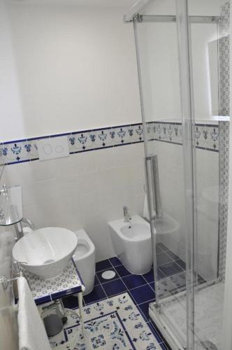 a bathroom with a shower and a toilet and a sink at SALERNO COSTA D'AMALFI SUITE in Salerno