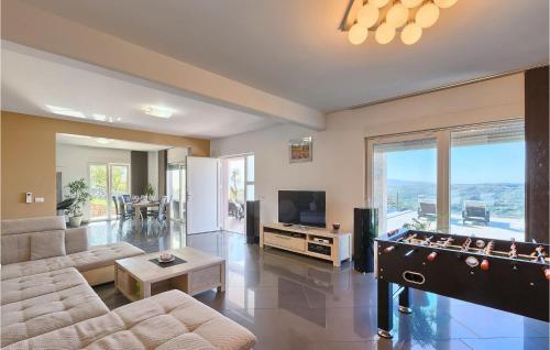 a living room with a pool table and a tv at Villa Amelie in Vicani