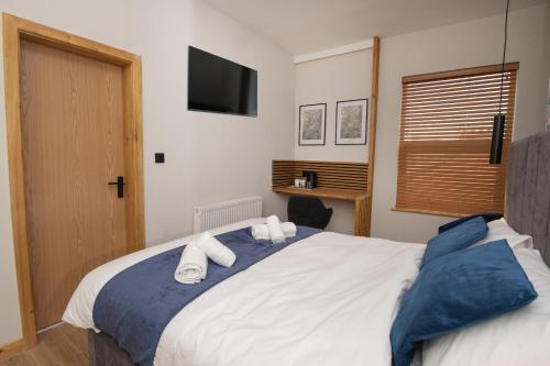 a bedroom with a bed with towels on it at Amber Hotel in Hull