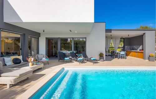 a house with a swimming pool and a patio at Villa Hedone Rakalj in Krasa