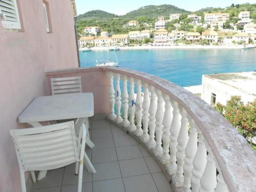 a balcony with a table and chairs and the water at Apartment Svetka in Sali